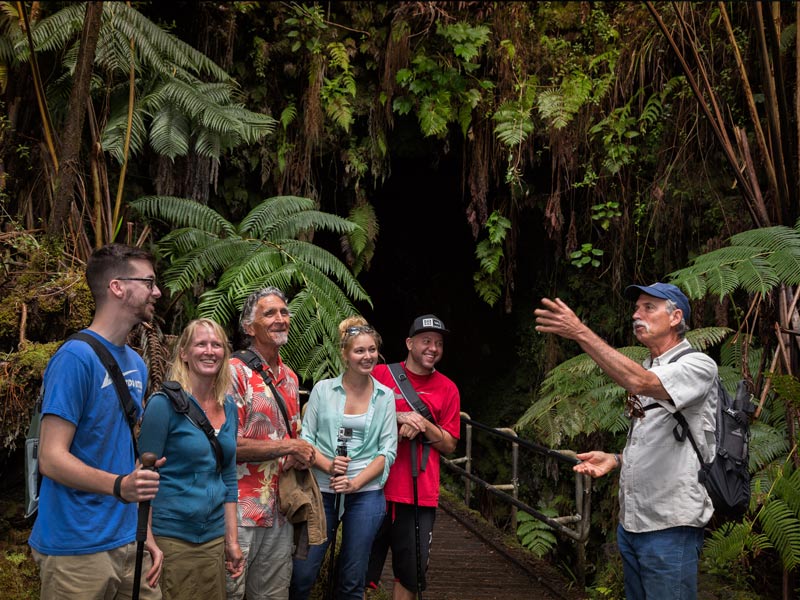 Tourists smiling on a tour through the Big Island of Hawaii Rainforrest