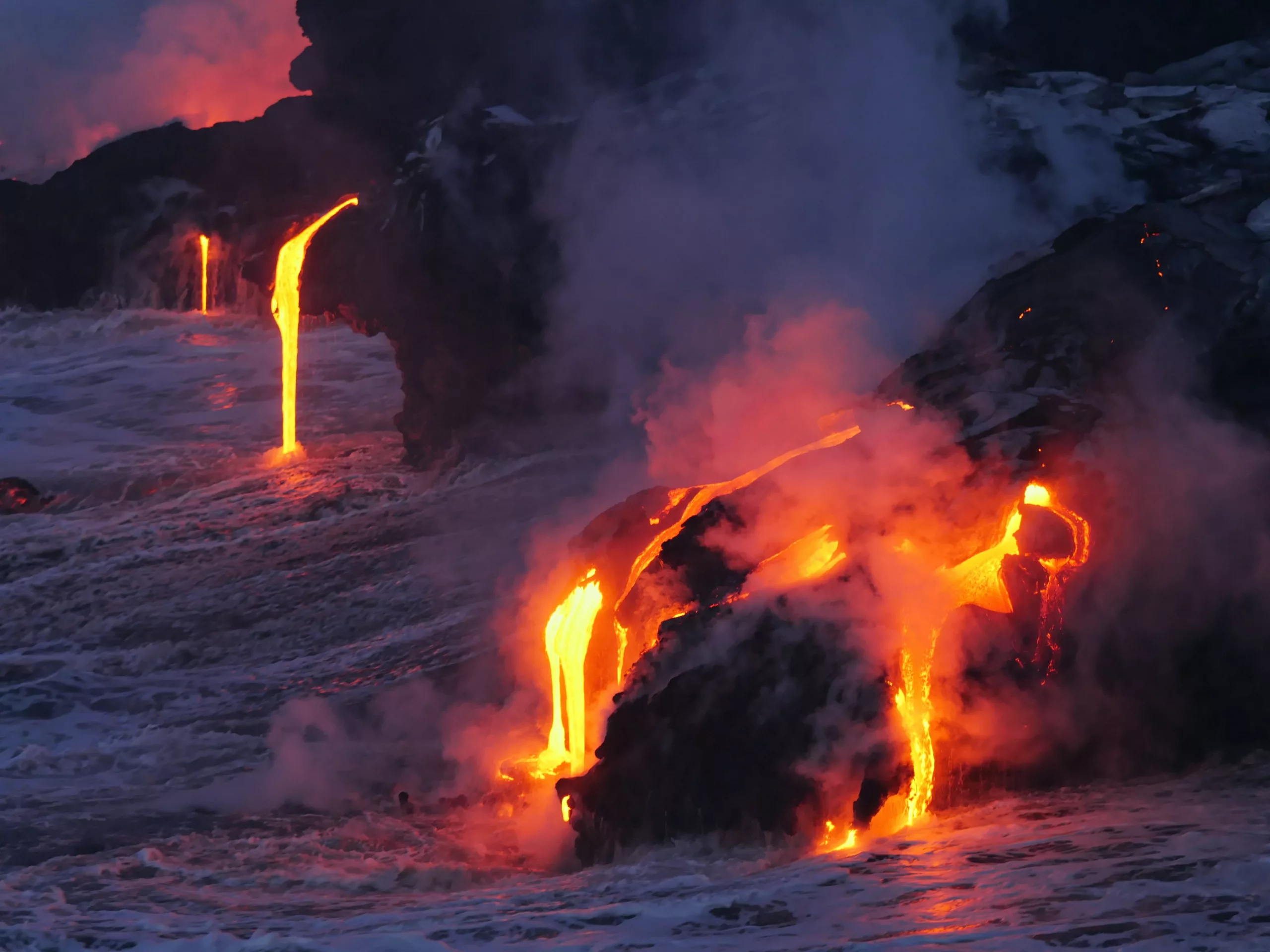 Lava Pouring into the Pacific Ocean from an erupting Kilauea, one of the active volcanoes in Hawaii