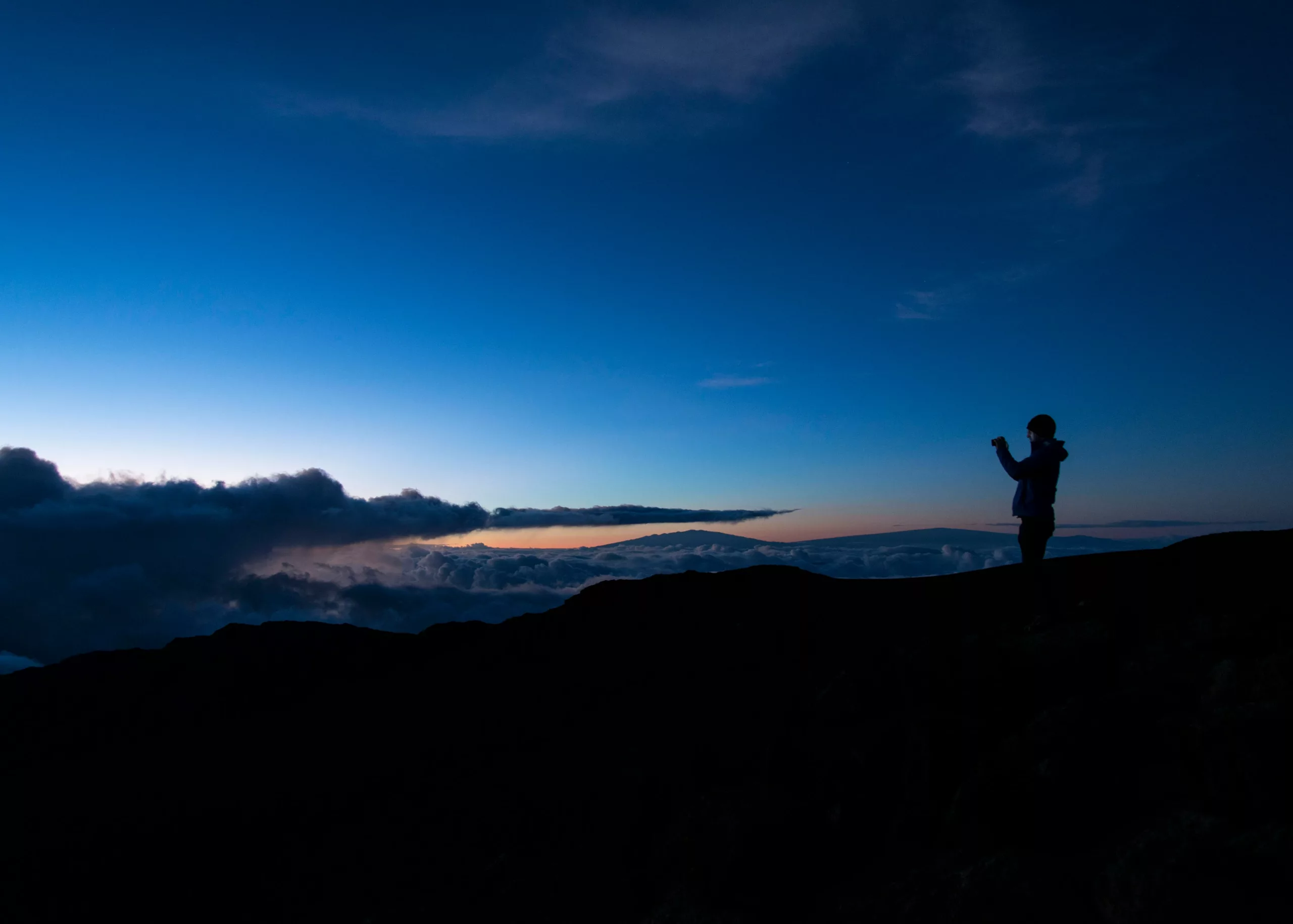 Person taking a picture of the sunrise in Haleakala National Park, Maui, Hawaii.